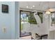 Sunroom has custom glass heron detail that looks out to the lake at 238 Southampton Dr # 319, Venice, FL 34293