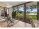 Relaxing sunroom with tile floors and rocking chairs with lake views at 238 Southampton Dr # 319, Venice, FL 34293