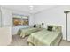 Cozy bedroom with neutral carpet and ceiling fan, offering a comfortable and relaxing retreat at 240 Lewis Cir # 28, Punta Gorda, FL 33950