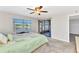 Bright bedroom with a lake view, neutral carpet, and a sliding glass door leading to the lanai at 240 Lewis Cir # 28, Punta Gorda, FL 33950