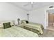 Comfortable bedroom featuring two beds, neutral carpet, and an ensuite bathroom for added convenience at 240 Lewis Cir # 28, Punta Gorda, FL 33950