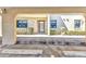 Exterior entrance showing concrete walkway, front door, two windows and landscape at 240 Lewis Cir # 28, Punta Gorda, FL 33950