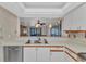 A kitchen with white cabinets that overlooks the living room at 240 Lewis Cir # 28, Punta Gorda, FL 33950