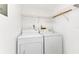 Functional laundry room with washer, dryer, and shelving, making laundry tasks simple and organized at 240 Lewis Cir # 28, Punta Gorda, FL 33950