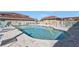 Community pool is surrounded by plenty of seating and umbrellas at 240 Lewis Cir # 28, Punta Gorda, FL 33950