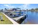 Boat on a lift at the dock with water access on a sunny day at 240 Lewis Cir # 28, Punta Gorda, FL 33950