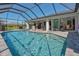 Enjoy the beautiful pool area complete with ample seating, grill, and a clear view of the home's interior at 25543 Prada Dr, Punta Gorda, FL 33955