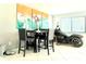 Modern dining area featuring a high-top table, chairs, and natural light, blending dining and style at 2715 Taylor Rd, Punta Gorda, FL 33950