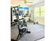 Home exercise room, featuring an exercise bike, bench press, and weights for home fitness at 2715 Taylor Rd, Punta Gorda, FL 33950