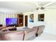 Spacious living room with large sectional sofa, ceiling fan, and lots of natural light at 2715 Taylor Rd, Punta Gorda, FL 33950