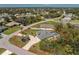 Aerial view of single Gathering home featuring a large driveway, landscaping, and screened pool at 27394 Natal Dr, Punta Gorda, FL 33983