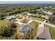 A high aerial of the property that shows the home sitting on a well manicured, tree lined lot at 27394 Natal Dr, Punta Gorda, FL 33983