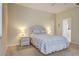 Light bedroom with a bed, window with blinds, carpeted floor, two nightstands, and a closet door visible at 2877 Woodward Ave, North Port, FL 34286