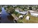 An aerial view displays a cozy home with quick access to a serene canal at 301 Palmetto Ne Dr, Port Charlotte, FL 33952