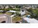 A high-angle view highlights a home near a canal and ample street and driveway parking at 301 Palmetto Ne Dr, Port Charlotte, FL 33952