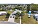 An aerial view of the home shows a neatly landscaped yard and cars in the driveway at 301 Palmetto Ne Dr, Port Charlotte, FL 33952