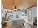 Bright bedroom featuring wood ceiling, tiled floor and nautical décor at 301 Palmetto Ne Dr, Port Charlotte, FL 33952