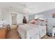 A bright bedroom featuring herringbone floors, a ceiling fan, and a white door at 301 Palmetto Ne Dr, Port Charlotte, FL 33952