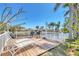 Waterfront deck with lounge chairs and a table set, ideal for relaxing by the water at 301 Palmetto Ne Dr, Port Charlotte, FL 33952