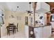 Cozy dining area featuring a breakfast bar connecting to an adjacent kitchen with ample natural light at 301 Palmetto Ne Dr, Port Charlotte, FL 33952