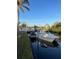 A dock and boat on the water is framed by a beautiful blue sky at 301 Palmetto Ne Dr, Port Charlotte, FL 33952