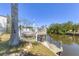Waterfront dock with seating, ideal for enjoying the scenery and boating activities by the canal at 301 Palmetto Ne Dr, Port Charlotte, FL 33952