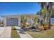 Inviting single-story home with a well-manicured lawn and tropical landscaping, plus a convenient garage at 301 Palmetto Ne Dr, Port Charlotte, FL 33952