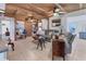 Cozy living room featuring a unique wood ceiling, neutral tile floors, and comfortable seating arrangements at 301 Palmetto Ne Dr, Port Charlotte, FL 33952