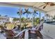 Spacious screened-in patio with comfortable seating overlooking a well-maintained yard with lush palm trees at 301 Palmetto Ne Dr, Port Charlotte, FL 33952