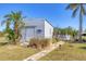 A shed is situated on a lush lawn, surrounded by trees, creating a tranquil atmosphere at 301 Palmetto Ne Dr, Port Charlotte, FL 33952
