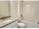 Bathroom featuring granite countertop on vanity with sink, white cabinets, toilet, and tile surround tub at 354 Porto Alegre St, Punta Gorda, FL 33983
