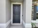 Close-up of a stylish front door with classic paneling and white trim at 354 Porto Alegre St, Punta Gorda, FL 33983