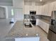 Well-equipped kitchen with a large island, stainless steel appliances, and stylish backsplash at 354 Porto Alegre St, Punta Gorda, FL 33983