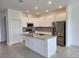 Bright kitchen features white cabinetry, stainless steel appliances, granite counters, and an island with a sink at 354 Porto Alegre St, Punta Gorda, FL 33983
