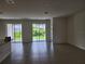 Open living area with tile flooring and glass sliding doors providing natural light and backyard views at 354 Porto Alegre St, Punta Gorda, FL 33983