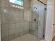 Modern tiled shower with glass door and window at 354 Porto Alegre St, Punta Gorda, FL 33983