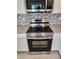 Stainless steel stove and microwave combo with white cabinets and granite countertops at 354 Porto Alegre St, Punta Gorda, FL 33983