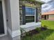 Detailed view of a home's exterior featuring a window with decorative shutters and stone accents at 354 Porto Alegre St, Punta Gorda, FL 33983