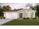 Charming single-story home with a two-car garage, neutral paint and a well-manicured lawn and minimal landscaping at 4700 Knollwood Dr, Punta Gorda, FL 33982