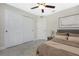 Bedroom featuring a ceiling fan, a grey headboard, and a closet with sliding doors at 481 Starborn St, Port Charlotte, FL 33954