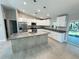 Modern kitchen featuring granite countertops, a central island, stainless steel appliances, and bright lighting at 481 Starborn St, Port Charlotte, FL 33954