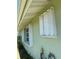 Side exterior view of the home highlighting windows and potential storm shutters at 548 Belvedere Ct, Punta Gorda, FL 33950