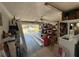 A cluttered garage with washer and dryer, storage, and access to outdoors at 548 Belvedere Ct, Punta Gorda, FL 33950