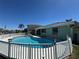 Backyard view of the fenced, kidney-shaped pool, patio, and partial view of the house at 548 Belvedere Ct, Punta Gorda, FL 33950
