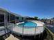 Backyard pool with white fence, patio, screened-in porch, and water view at 548 Belvedere Ct, Punta Gorda, FL 33950