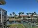 Water view showcases canal front homes with palm trees and dock at 548 Belvedere Ct, Punta Gorda, FL 33950