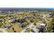 Expansive aerial view of a quiet residential neighborhood with well-maintained lawns and palm tree landscaping at 569 Royal Poinciana, Punta Gorda, FL 33955