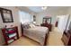 Bedroom features a comfortable bed, ensuite bathroom access, and window at 569 Royal Poinciana, Punta Gorda, FL 33955