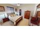Comfortable bedroom with wood furniture, carpeted floor, and walk-in closet at 569 Royal Poinciana, Punta Gorda, FL 33955
