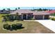 Beautiful single-story home featuring a tile roof, a spacious front lawn, and a two-car garage at 569 Royal Poinciana, Punta Gorda, FL 33955